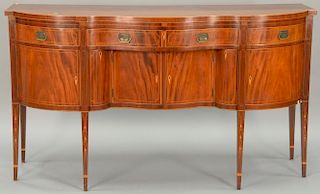 Margolis mahogany sideboard having shaped top over conforming case having central serpentine drawer over two doors and two bo