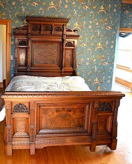 Two piece Victorian walnut bedroom set to include bed having three dimensional carved panels along with burlwood recessed pan