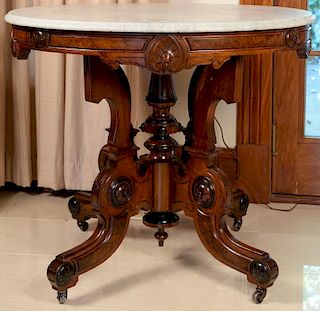 Victorian walnut table with oval marble top. ht. 30in., top: 27" x 36" Provenance: Property from the Estate of Frank Perrotti