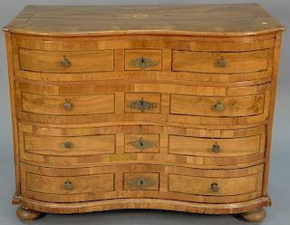 Continental oxbow four drawer chest having shaped top with inlays over conforming inlaid drawers, all set on suppressed ball