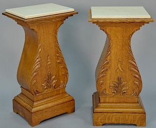 Pair of oak pedestals, each with newer marble top. ht. 34in., top: 15" x 18" Provenance: Property from the Estate of Frank Pe