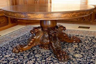 Victorian round oak table having center pedestal carved with screaming lions foliate carving and large claw feet