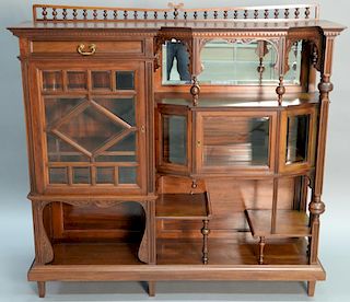 Pair of Aesthetic movement mahogany curio cabinets having one drawer, two doors, and various shelves