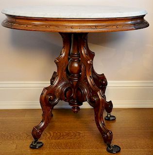 Victorian walnut oval marble top table. ht. 29 1/2in., top: 23" x 32" Provenance: Property from the Estate of Frank Perrotti