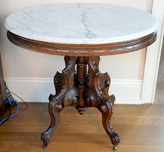 Oval Victorian walnut marble top table. ht. 29 1/2in., top: 24" x 33" Provenance: Property from the Estate of Frank Perrotti