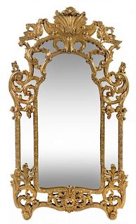 A Regence Style Giltwood Mirror Height 55 x width 32 inches.