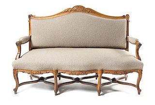 A Louis XV Style Oak Settee Height 44 x width 64 x depth 23 inches.