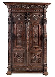 * A Renaissance Revival Carved Oak Cabinet Height 86 1/2 x width 50 1/2 x depth 19 1/2 inches.