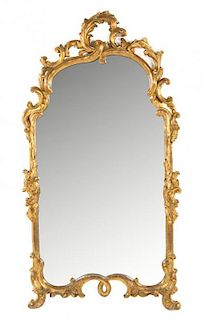 An Italian Rococo Style Giltwood Mirror Height 60 x width 32 inches.