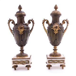 * A Pair of Continental Cast Metal Urns and Two Associated Stands Height 16 1/2 inches.