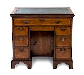 A George II Walnut Kneehole Desk Height 31 x width 34 1/8 x depth 20 3/8 inches.