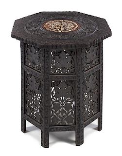 An Anglo-Indian Carved Rosewood Table Height 25 1/2 x width of top 24 inches.