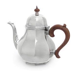 An American Silver Teapot, Retailed by Cartier, of paneled baluster form.