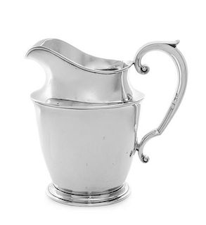 An American Silver Water Pitcher, Watson Company, Attleboro, MA, having a spurred handle, raised on a circular foot.