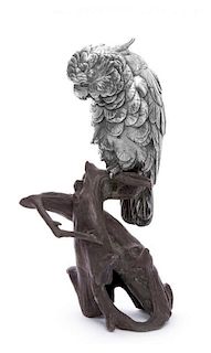 A French Silvered Metal Figure of a Cockatoo, Late 19th/Early 20th Century, raised on a naturalistic bronze base.