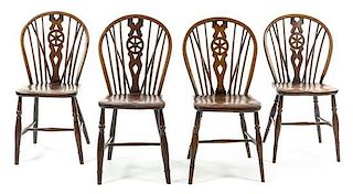 A Set of Four Oak Windsor Chairs Height 33 3/4 inches.