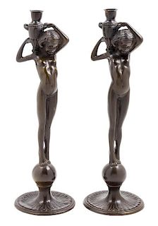 * A Pair of Patinated Metal Figural Candlesticks Height 15 5/8 inches.