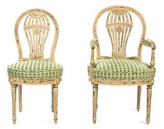 A Set of Fourteen Louis XVI Style Carved and Painted Balloon-Back Dining Chairs Height 37 1/2 inches.
