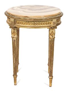 A Louis XVI Style Carved and Parcel Gilt Gueridon Height 24 1/2 x diameter 19 1/2 inches.
