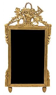 A Louis XVI Style Carved Giltwood Mirror Height 45 1/4 x width 23 3/4 inches.