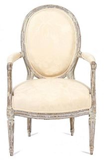 A Louis XVI Style Carved and Painted Fauteuil Height 35 inches.