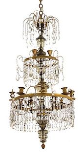 A French Empire Style Gilt Metal and Beaded Crystal Birdcage Style Eleven-Light Chandelier Height 33 x diameter 18 inches.