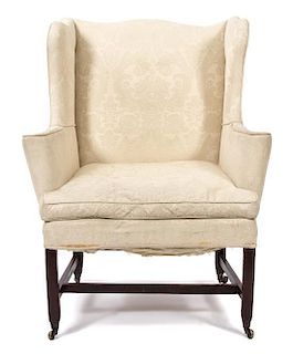 A George III Mahogany Wing Chair Height 43 x width 33 1/2 x depth 32 inches.