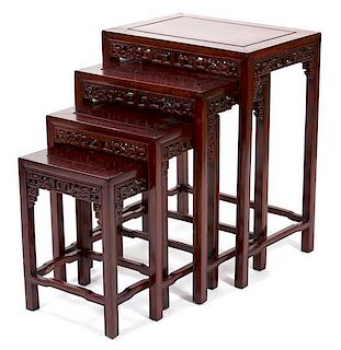 A Chinese Carved Hardwood Nest of Four Tables Height 19 1/2 inches.