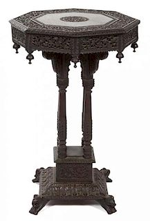 An Anglo-Indian Carved Teak Side Table Height 32 x diameter 22 inches.