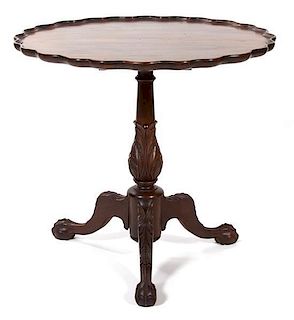 A George II Style Carved Mahogany Tripod Table Height 29 x diameter 31 inches.