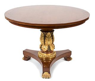A Regency Mahogany and Gilt Decorated Center Table Height 28 1/2 x diameter 42 inches.