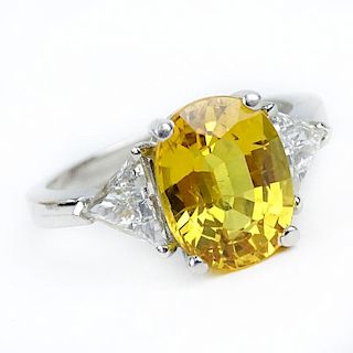 Approx. 4.33 Carat Oval Cut Yellow Sapphire, .78 Carat Trillion Cut Diamond and Platinum Ring.