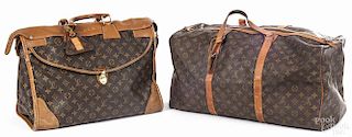 Three Louis Vuitton monogrammed luggage bags.