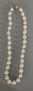 String of cultured pearls with 14 karat clasp. 9-11mm, lg. 17in.