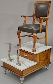 Oak shoeshine stand with oak leather upholstered chair set on marble tops. ht. 61in., wd. 26in. Provenance: Property from the