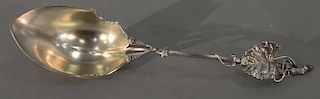 Gorham sterling silver serving spoon with leaf decorated handle.