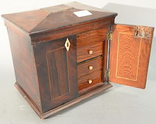 Continental mahogany miniature cabinet having lift top with compartments for jewels over two doors opening to reveal three dr