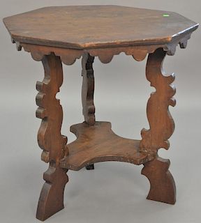 Continental side table with octagon top on carved leg supports. ht. 26in., top: 26 1/2" x 23 1/2"