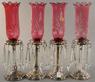 Set of four silverplate hurricane lamps with cranberry etched shades. ht. 20in. Provenance: Property from the Estate of Frank