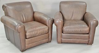 Pair of leather upholstered easy chairs.