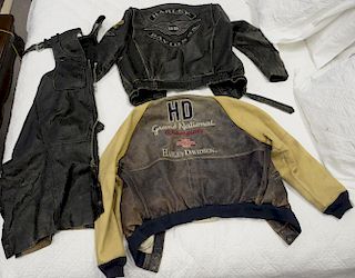 Three piece Harley Davidson lot to include two leather jackets, one is two-tone, along with a pair of leather chaps.