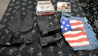 Large Harley Davidson lot to include large denim vest, a small leather Harley leather vest, a pair of gloves, skull cap, a pa