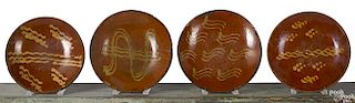 Four Pennsylvania redware chargers, 19th c.