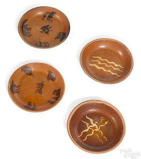 Four redware shallow bowls, 19th c.