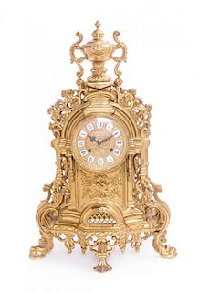 An Italian Gilt Brass Three-Piece Clock Garniture Height of clock 22 3/4 inches.