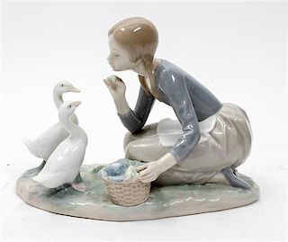 A Lladro Porcelain Figure Height 7 inches.
