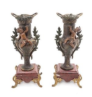 * A Pair of Continental Cast Metal Urns Height 14 1/4 inches.