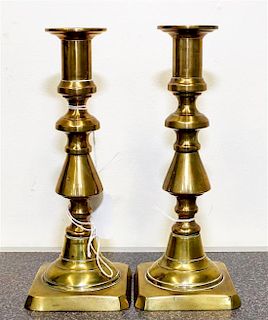 A Pair of Brass Candlesticks Height 8 inches.