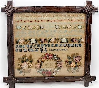 A Victorian Needlework Sampler Height 17 1/4 x width 19 inches.