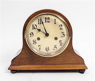 * An American Walnut Mantel Clock Height 9 3/8 x width 11 1/2 inches.